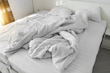 Fototapeta na wymiar Rumpled bedding on the bed after sleeping.