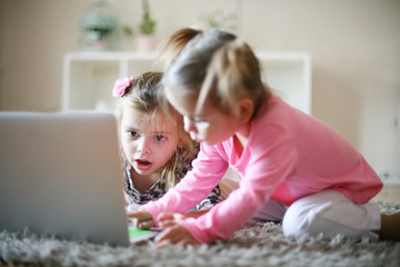 Fototapeta na wymiar Little girls and laptop.