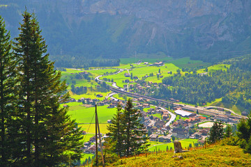beautiful village in Switzerland, top view, rustic houses on green meadow