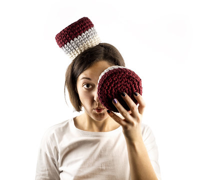 Portrait of young and gorgeous woman isolated on white background having fun with colorful crocheted baskets. Close up.