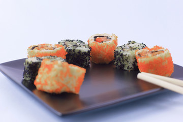 Sushi and rolls. the set is served on a black plate