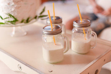 Glass cups with milk and straw