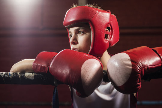A young make boxer reflecting on the ring before a fight