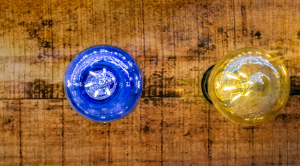 blue and yellow light bulb on wood background