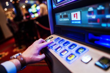 Men Playing Slot Machine