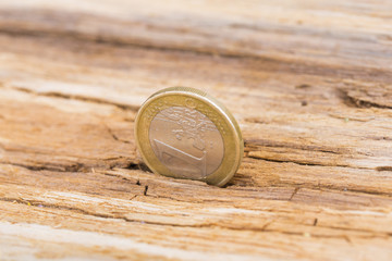 Financial crisis concept. Euro coin on old wooden background Horizontal