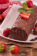 Chocolate roll with strawberries. 