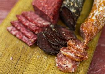 Smoked sausages are cut on a cutting board.