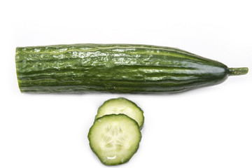 Cut cucumber with knife on the white