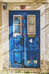 Naklejka na ściany i meble Old blue door in narrow street