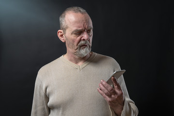 old man does not understand his smart phone