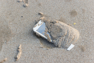Fototapeta na wymiar Mobile phone floated to the sea at the beach.