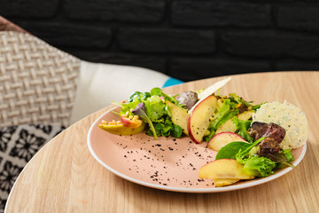 Warm mix salad with apple and fried liver