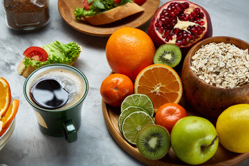 Breakfast still life with oatmeal porridge, fruits and coffee cup, top view, selective focus, shallow depth of field.