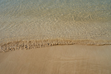 Fototapeta na wymiar Wave of the sea on the sand beach background, Copy space