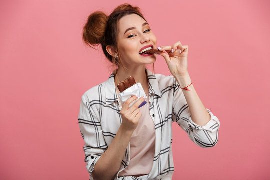 Portrait Of A Lovely Young Girl Eating Chocolate Bar