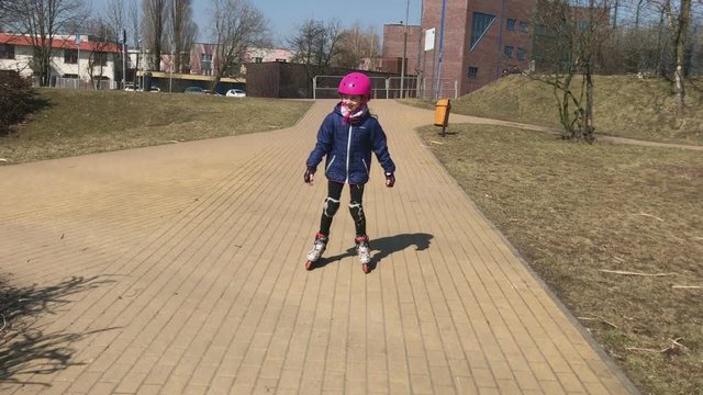 Little girl rollerskating.