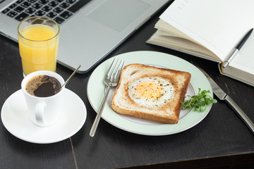 Business breakfast. Egg fried in toast with coffee and orange juice
