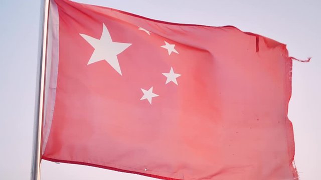 Chinese red flag flutters in wind