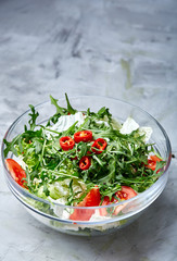Dietary mixed salad in glass sultana on white textured background, selective focus, vertical