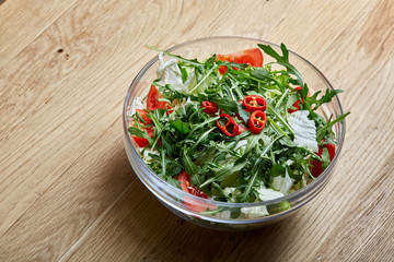 Dietary mixed salad in glass sultana on rustic wooden background, selective focus