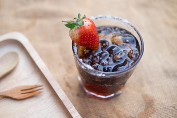 Refreshing summer drink with ice strawberries