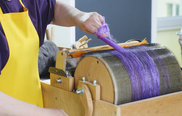 Felting wool. The step of combing the material in a special carding machine.
