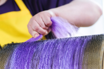 Felting wool. Combing the wool of alpaca or llama before felting on a special machine with a drum...