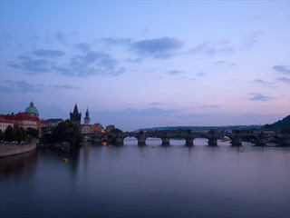 Fototapeta na wymiar Late evening panorama of the famous medieval pedestrian only Charles bridge (Karluv Most) in the center of Prague, Czech Republic