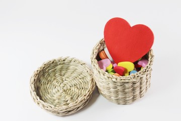 Fototapeta na wymiar Red heart in straw basket.