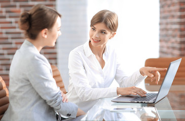woman Manager shows the client information on the laptop.