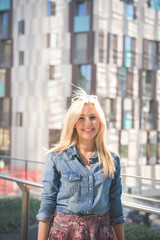 Young beautiful caucasian blonde girl in the city