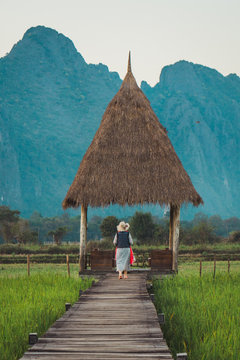 Woman standing at straw arbor