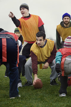 Caucasian man playing quarterback for an non-contact flag football team of friends.