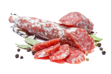 Dried organic salami sausage on white background