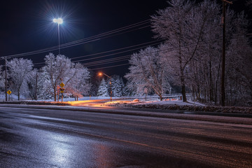 Night photo of the street with trees in the frost and snow. USA. Maine. Portland. Sako.
