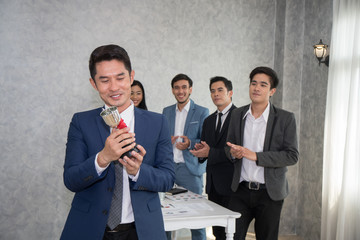 Employee showing the trophy award for success in business.