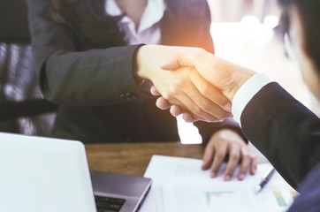 business man and business woman shaking hand in office for complete business deal together successful. teamwork concept. partnership concept and dealership concept.