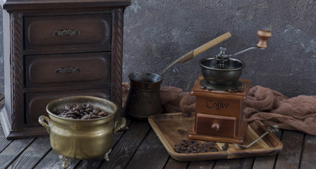on the table a coffee grinder, a locker, a Turk, coffee and coffee beans