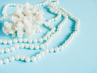 White shell coral with pearl beads a blue background