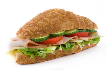 Croissant sandwich with cheese, ham and vegetables. Isolated on white background. Close up

