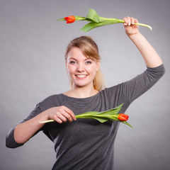Blond lady holding two tulips.