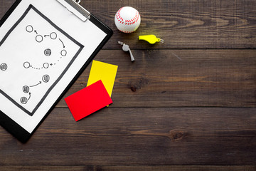 Sport judging concept. Baseball referee. Tactic plan for game, base-ball ball, red and yellow cards, whistle on wooden background top view copy space