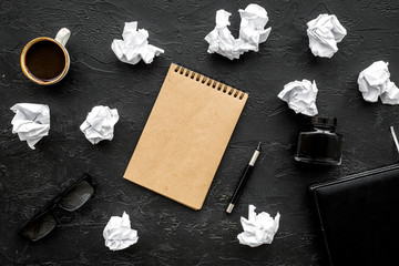 notebook, ink, dip pen, coffee, glasses for writer workplace set on dark office background top view mock-up