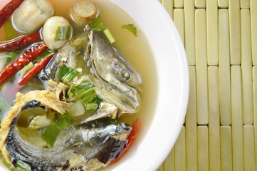 boiled smoked dry snake head fish in spicy and sour soup on bowl
