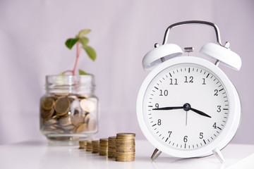 Saved money and a clock on a white background