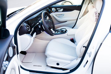 Luxury car interior. Steering wheel, shift lever and dashboard.