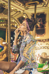 Obraz na płótnie Canvas Stylish woman wearing sparkling jacket on the carousel