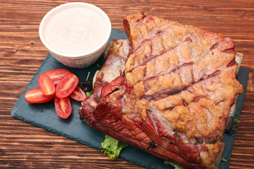 Delicious smoked beef ribs on an old rustic wooden chopping boar