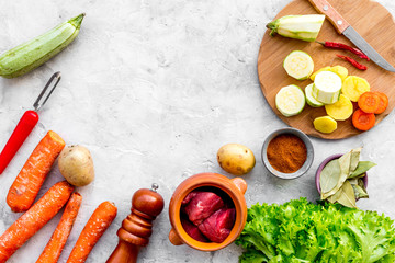 ingredients for vegetable ragout cooking on stone table background top view mock-up